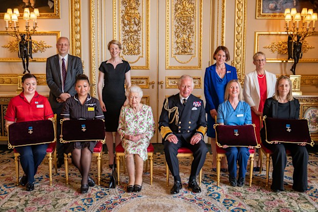 Queen Elizabeth II presents the George Cross to representatives of the National Health Service Mr Peter May, Permanent Secretary at the Department of Health and Chief Executive of Health and Social care, and Sister Joanna Hogg, Royal Victoria Hospital Emergency Department, during an Audience at Windsor Castle on July 12, 2022 in Windsor, England. (Photo by Aaron Chown - Pool/Getty Images)