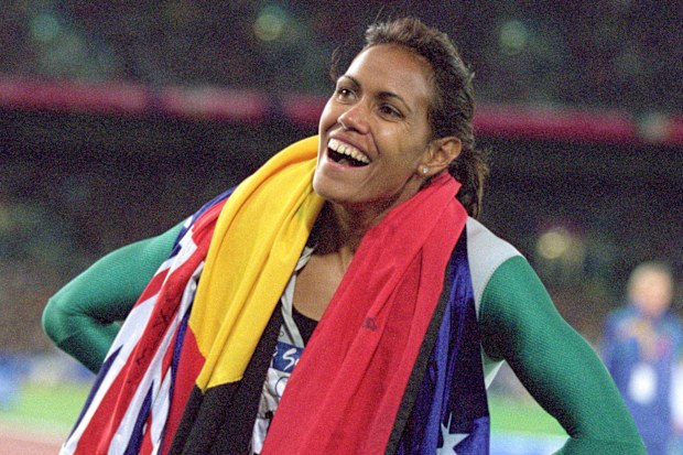 Cathy Freeman of Australia is elated after winning gold in the 400m final during the 2000 Sydney Olympic Games. 