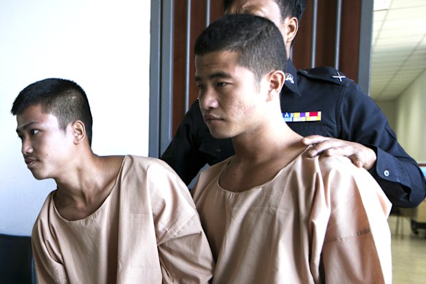 Myanmar migrants Win Zaw Htun, right, and Zaw Lin, left, both 22, are escorted by officials after their guilty verdict at court in Koh Samui, Thailand, in 2015.