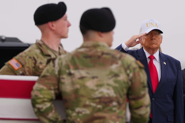 President Donald Trump salutes as an Army carry team moves the flag-draped transfer case containing the remains of U.S. Army Reserve Sgt. Declan Coady, 20.
