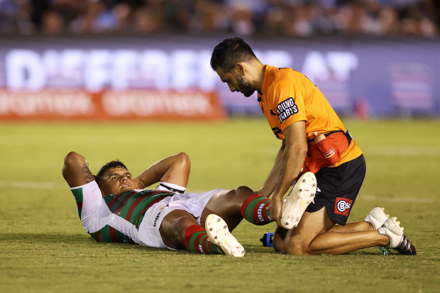 Latrell Mitchell of the Rabbitohs receives attention from the trainer during the round one NRL match between Cronulla Sharks and South Sydney Rabbitohs at BlueBet Stadium on March 04, 2023 in Cronulla, Australia. (Photo by Mark Kolbe/Getty Images)