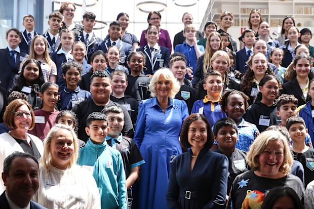 Queen Camilla (C) poses for a group photo with students, authors and representatives from the NSW Government during a visit to the Green Square Library on October 22, 2024 in Sydney, Australia. The queen and King Charles III's visit to Australia is his first as monarch, and the Commonwealth Heads of Government Meeting (CHOGM) in Samoa will be his first as head of the Commonwealth. 