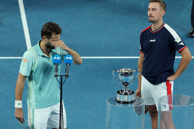 Hugo Nys (left) fights tears after he and Jan Zielinski lost their Australian Open men's doubles final at Rod Laver Arena.