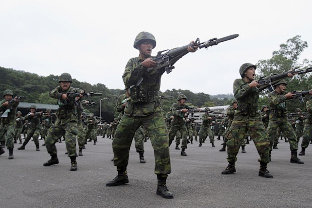 FILE - New recruits practice thrusting with their bayonets at a military training center in Hsinchu County, northern Taiwan on April 22, 2013. Taiwan will extend its compulsory military service from four months to a year starting in 2024, President Tsai Ing-wen said Tuesday, Dec. 27, 2022, as the self-ruled island faces China's military, diplomatic and trade pressure. (AP Photo/Chiang Ying-ying, File)