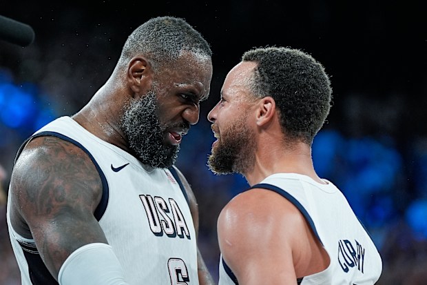 PARIS, FRANCE - AUGUST 8: Lebron James of United States and Stephen Curry of the United States celebrate their victory and entry into the Final at the final whistle during the Men's Semifinal Game between United States and Serbia on day thirteen of the Olympic Games Paris 2024 at Arena Bercy on August 8, 2024 in Paris, France. (Photo by Daniela Porcelli/Eurasia Sport Images/Getty Images)