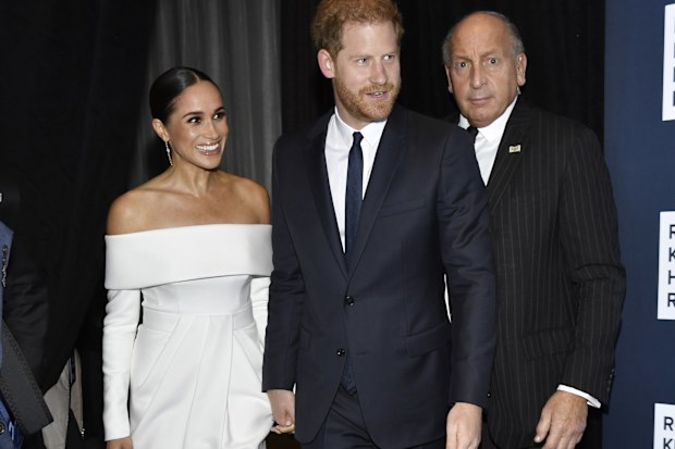 Meghan, Duchess of Sussex, left, and Prince Harry, center, attend the Robert F. Kennedy Human Rights Ripple of Hope Awards Gala at the New York Hilton Midtown on Tuesday, Dec. 6, 2022, in New York. (Photo by Evan Agostini/Invision/AP)