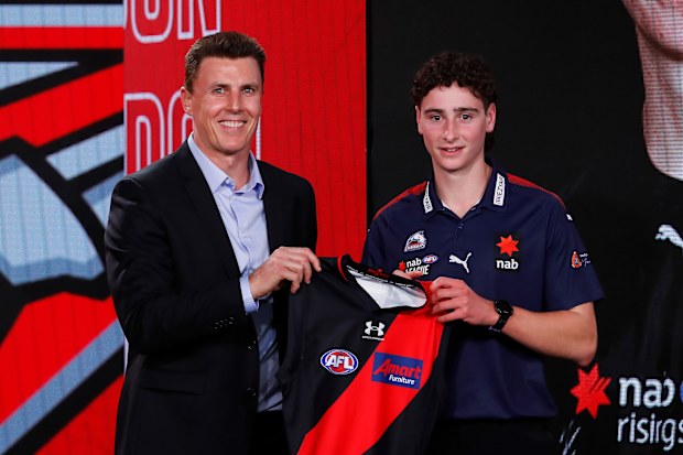MELBOURNE, AUSTRALIA - NOVEMBER 28: Elijah Tsatas of the Oakleigh Chargers poses for a photo with Bombers legend Matthew Lloyd during the 2022 NAB AFL Draft at Marvel Stadium on November 28, 2022 in Melbourne, Australia. (Photo by Dylan Burns/AFL Photos)