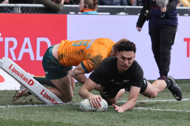 Shaun Stevenson scores a try on debut, despite Andrew Kellaway's best effort to stop him at Forsyth Barr Stadium.