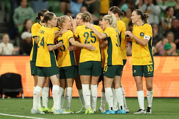 Matildas players celebrate after scoring a goal against Chinese Taipei.