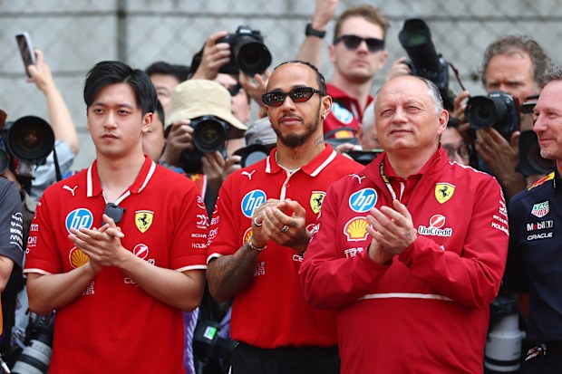 Zhou Guanyu of China and Scuderia Ferrari, Lewis Hamilton of Great Britain and Scuderia Ferrari and Frederic Vasseur, Team Principal of Scuderia Ferrari stand in tribute to the late Eddie Jordan prior to the F1 Grand Prix of China at Shanghai International Circuit on March 23, 2025 in Shanghai, China. (Photo by Bryn Lennon - Formula 1/Formula 1 via Getty Images)