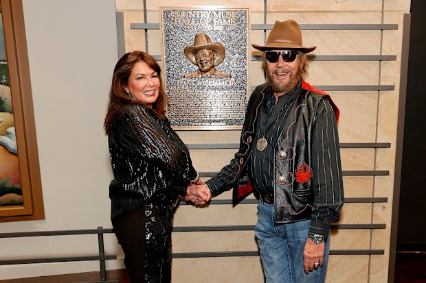 Mary Jane Thomas and 2020 inductee Hank Williams Jr. seen during the 2021 Medallion Ceremony, celebrating the Induction of the Class of 2020 at Country Music Hall of Fame and Museum on November 21, 2021 in Nashville, Tennessee.