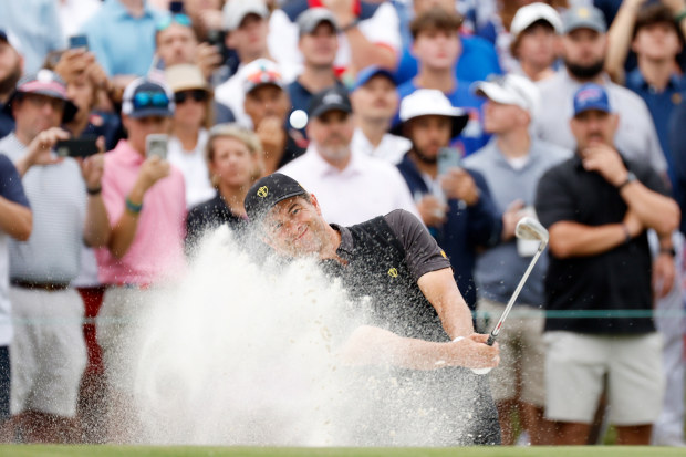 Adam Scott of Australia and the International Team plays a shot from a bunker on the 15th hole during Sunday singles matches on day four of the 2022 Presidents Cup at Quail Hollow Country Club on September 25, 2022 in Charlotte, North Carolina. (Photo by Jared C. Tilton/Getty Images)