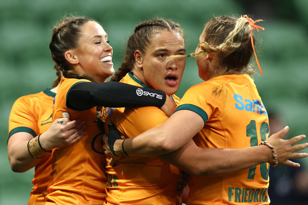 Ashley Marsters of Australia is congratulated by teammates after scoring a try.
