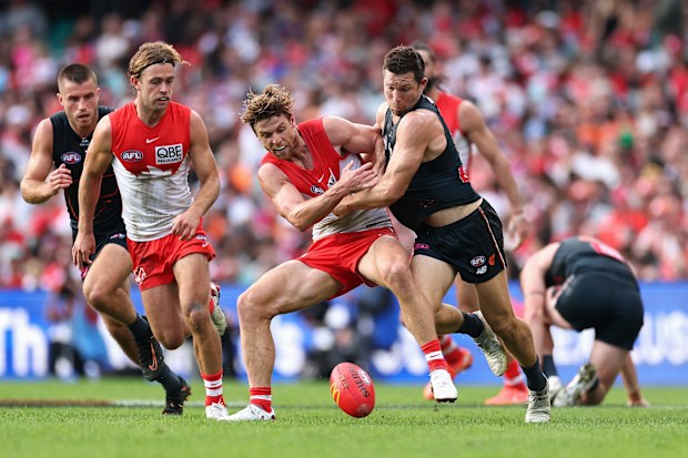 Dane Rampe of the Swans and Toby Greene of the Giants contest the ball.