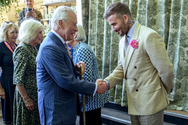 David Beckham, wearing the King's Rose, with King Charles and Queen Camilla during a visit to the Chelsea Flower Show on Monday May 19, 2025.