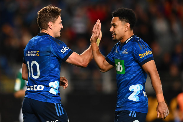 Beauden Barrett of the Blues celebrates after scoring a try with Stephen Perofeta.