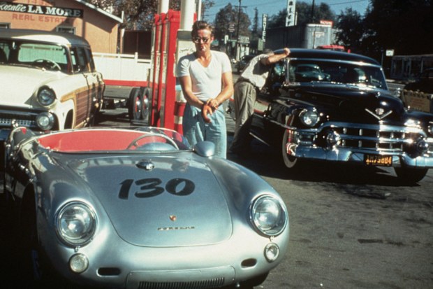 James Dean at a gas station with his silver Porsche 550 Spyder he named Little Bastard, just hours before his fatal crash.