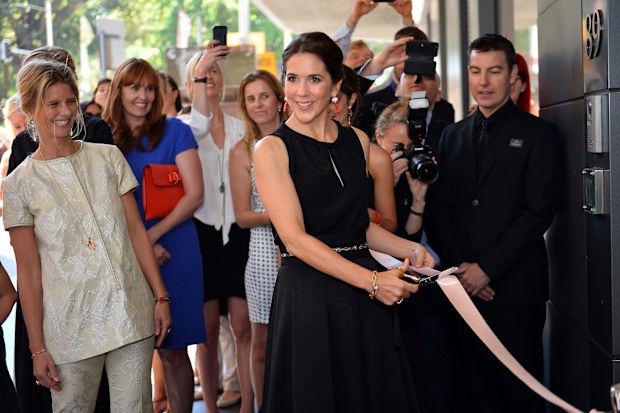 Crown Princess Mary of Denmark cuts a ribbon for an official opening of Ole Lynggaard Flagship Store in the  central business district of Sydney on October 25, 2013. The royal couple, attending celebrations for the 40 year anniversary of the Sydney Opera House, are on a five-day official visit to Australia. AFP PHOTO/ Saeed KHAN / POOL