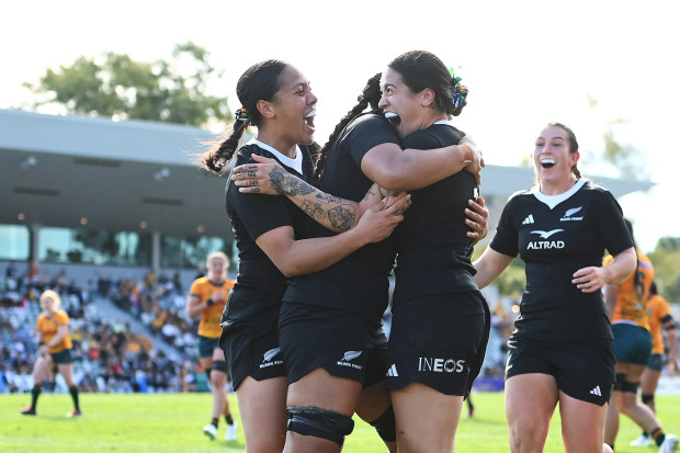 Katelyn Vahaakolo of the Black Ferns celebrates with teammates after scoring a try.