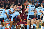 <p>A concussed Selwyn Cobbo is protected by teammate Dane Gagai as a scuffle erupts around them.</p><p>Cobbo was subsequently stretchered after his head collided heavily with the hip of fellow Maroon Patrick Carrigan.</p><p>"This young man, he's in Disneyland," said Andrew Johns on commentary as the two teams came together.</p><p>Cameron Smith described it as 'all out warfare' as the game was stopped for several minutes to allow for Cobbo to be safely removed.</p>