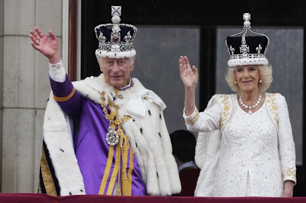 King Charles III and Queen Camilla wave to the crowds from the balcony of Buckingham Palace after the coronation ceremony in London, Saturday, May 6, 2023. 