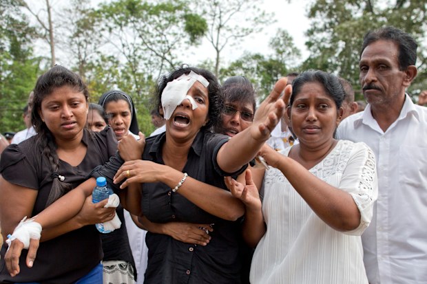 A grieving widow mourns her family who were killed when e=several blasts went off at churches and hotels around Sri Lanka on Easter Sunday.
