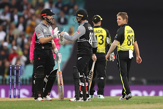 SYDNEY, AUSTRALIA - OCTOBER 22: Kane Williamson of New Zealand and Devon Conway of New Zealand react as Adam Zampa of Australia looks at them during the ICC Men's T20 World Cup match between Australia and New Zealand at Sydney Cricket Ground on October 22, 2022 in Sydney, Australia. (Photo by Mark Kolbe/Getty Images)