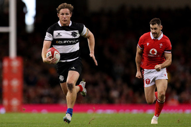 Michael Hooper of the Barbarians runs with the ball.