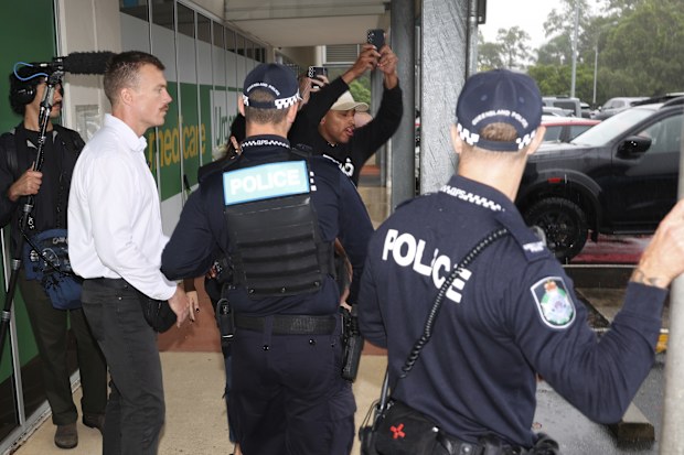 A heckler (in black holding phone) shouts as Prime Minister Anthony Albanese departs the Murrumba Downs Medical and Dental Centre, in the electorate of Dickson, in Murrumba Downs, Queensland on Saturday 29 March 2025. fedpol Photo: Alex Ellinghausen
