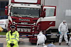 Forensic police officers attend the scene after a truck was found to contain a large number of dead bodies, in Grays, England, October 23, 2019.  