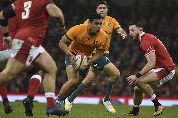 Len Ikitau, centre, runs with the ball during the rugby union international match between Wales and Australia 