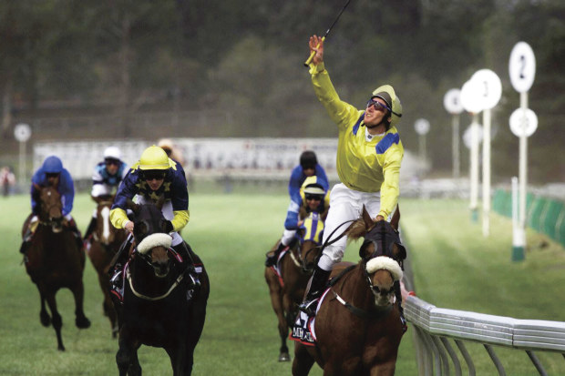 Damien Oliver blows a kiss to his brother Jason as Media Puzzle wins the 2002 Melbourne Cup.