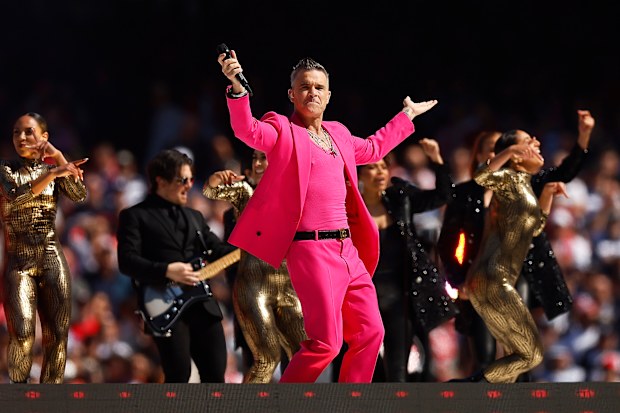 Robbie Williams performs during the 2022 AFL Grand Final match between the Geelong Cats and the Sydney Swans at the Melbourne Cricket Ground on September 24, 2022 in Melbourne, Australia. (Photo by Daniel Pockett/AFL Photos/via Getty Images)