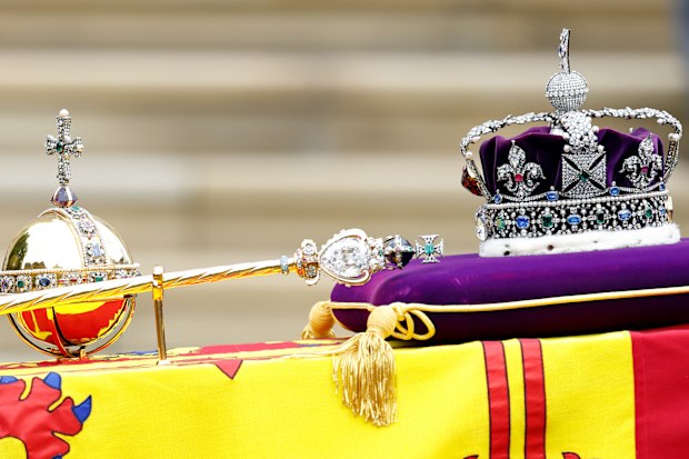 The Sovereign's Orb, Sceptre and The Imperial State Crown sit on top of Queen Elizabeth II's Royal Standard draped coffin