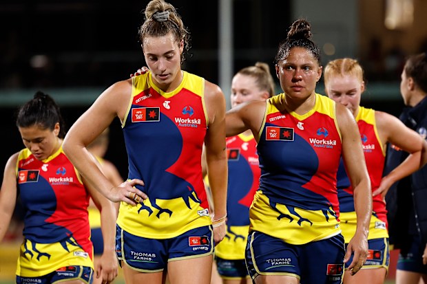 The Crows are dejected after their preliminary final loss to the Lions.