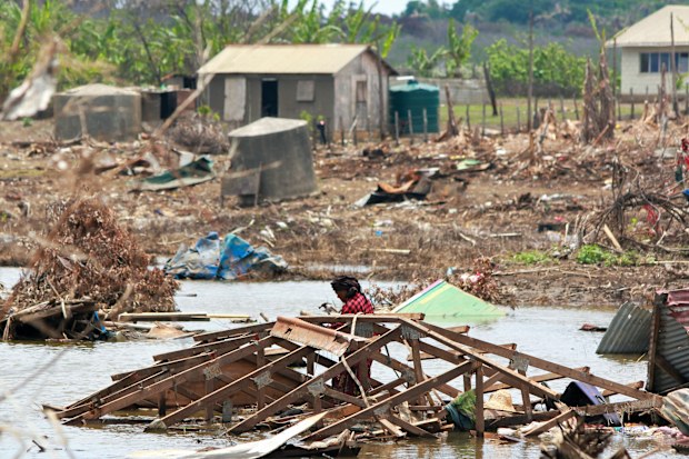 In this photo supplied by the Royal Australian Navy, a resident of Nomuka Island in Tonga clears debris on Feb. 26, 2022, following the Jan. 15 2022 eruption of the Hunga TongaHunga Ha'apai volcano and subsequent tsunami. Three months on from a devastating volcano and tsunami in Tonga, the AP checks in on how the island nation is recovering. The bill from the tsunami is estimated at some $90 million and GDP is expected to fall by more than 7% this year. The cleanup has been hindered by an intern
