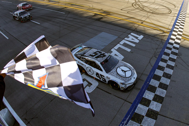 Tyler Reddick, driver of the No.45 Jordan Brand Toyota, takes the checkered flag to win the NASCAR Cup Series race at Talladega Superspeedway.