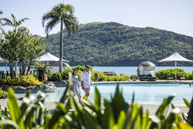 Couple walking to the waterfront swimming pool, Daydream Island
