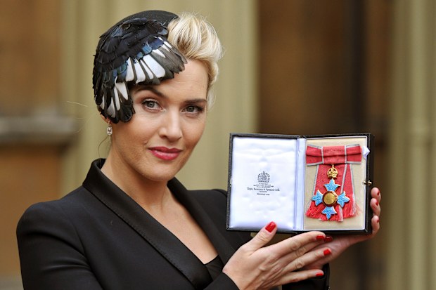 British actress Kate Winslet displays her CBE, for services to drama, which was awarded to her by Queen Elizabeth II, during an Investiture ceremony at Buckingham Palace in central London, Wednesday Nov. 21, 2012. (AP Photo/ John Stillwell/Pool)