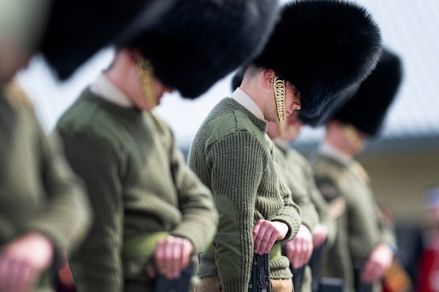 Soldiers from the Welsh Guards bow their heads as they rehearse for Britain's Prince Philip's funeral on the Drill Square at the Army Training Centre Pirbright in Woking, Surrey, England Wednesday April 14, 2021. 