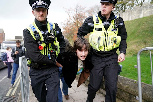 Police detain a protester after he appeared to throw eggs at King Charles III and the Queen Consort as they arrived for a ceremony at Micklegate Bar, where the Sovereign is traditionally welcomed to the city, in York, England, Wednesday November 9, 2022.