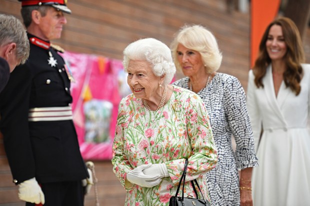 Britain's Queen Elizabeth II , centre, Camilla, the Duchess of Cornwall and Kate, the Duchess of Cambridge, attend an event in celebration of 'The Big Lunch 'initiative, during the G7 summit in Cornwall, England, Friday June 11, 2021. (Oli Scarff/Pool Photo via AP)