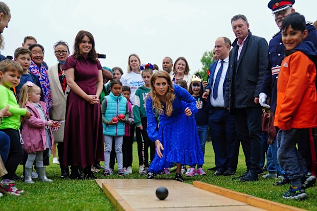 Princess Beatrice, centre, and Princess Eugenie play on the bowling alley during the Big Jubilee Lunch organized by Westminster Council 