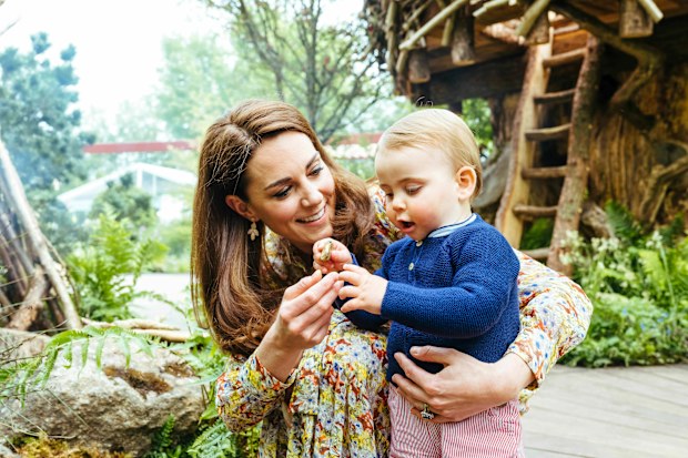 In this image made available on Sunday May 19, 2019 by Kensington Palace, Britain's Kate, Duchess of Cambridge and her son Prince Louis play in the Adam White and Andree Davies co-designed garden ahead of the RHS Chelsea Flower Show in London. (Matt Porteous/Kensington Palace via AP)