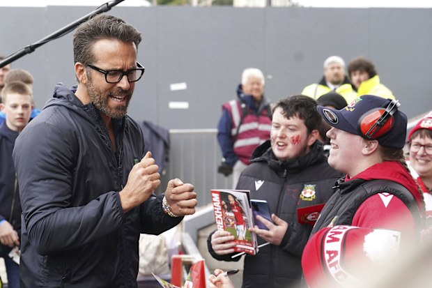 Wrexham co-owner Ryan Reynolds reacts with fans ahead of the National League soccer match between Wrexham and Boreham Wood at The Racecourse Ground, in Wrexham, Wales, Saturday April 22, 2023.