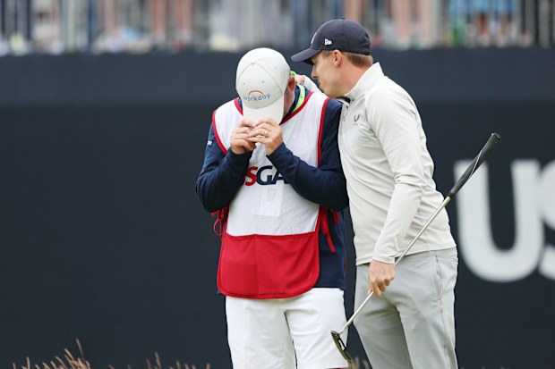 Matt Fitzpatrick of England celebrates with caddie Billy Foster after winning on the 18th green during the 2022 US Open.
