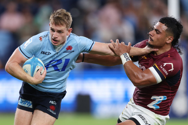 Max Jorgensen of the Waratahs is tackled by Tanielu Telea of the Highlanders.