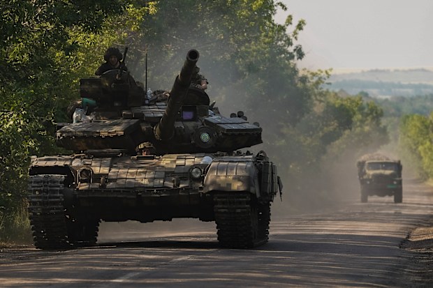A Ukrainian tank drives in Donetsk region, eastern Ukraine, Thursday, June 9, 2022. 