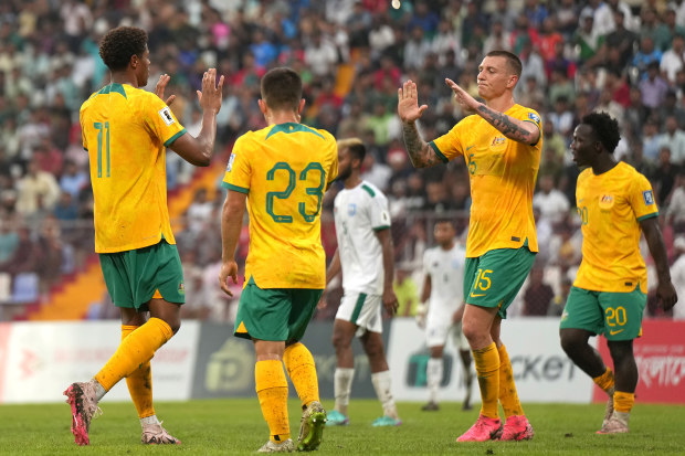 Kusini Yengi of Australia (L) celebrates scoring his side's second goal with his teammate during the FIFA World Cup Asian second qualifier Group I match between Bangladesh and Australia at Bashundhara Kings Arena on June 6, 2024 in Dhaka, Bangladesh. (Photo by Thananuwat Srirasant/Getty Images)
