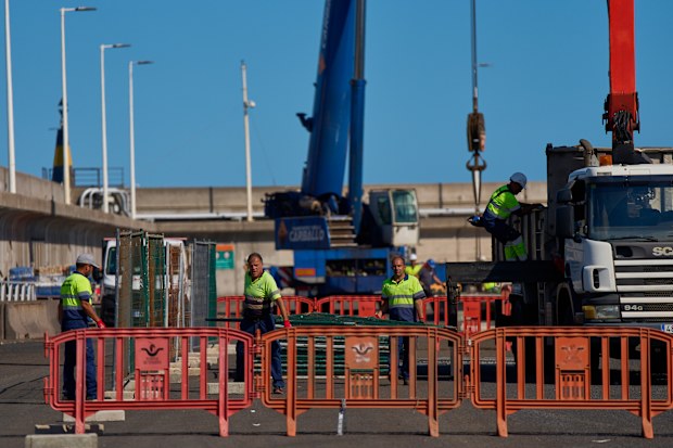Workers prepare the area where passengers from the MV Hondius cruise ship are expected to arrive at the port of Granadilla in Tenerife, Canary Islands, Spain, Friday, May 8, 2026.